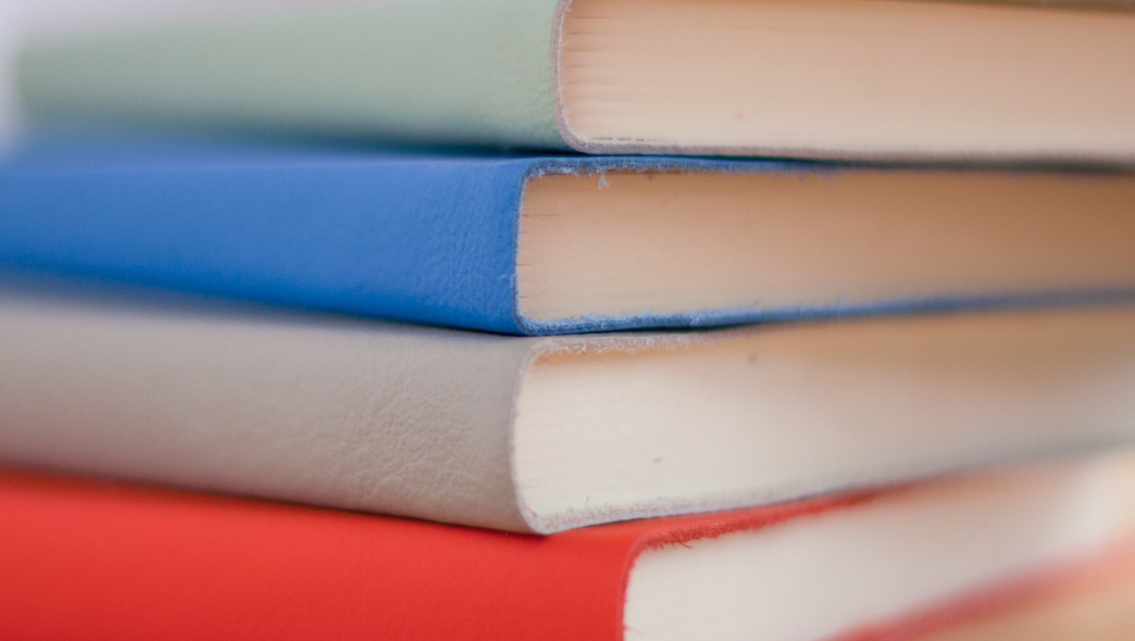 four books on table