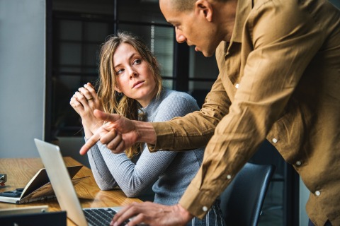 Women at laptop listening to man