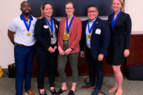 Students posing for a picture after winning the regional simulation competition